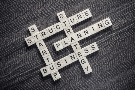 Words of business marketing collected in crossword with wooden cubesの写真素材