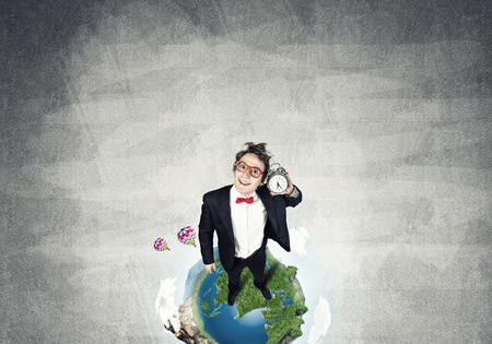 Funny disheveled businessman with alarm clock from top view. Elements of this image are furnished by NASAの写真素材