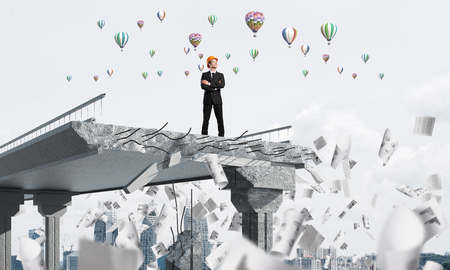 Confident engineer in helmet standing among flying papers on broken bridge with flying balloons on background. 3D rendering.の写真素材