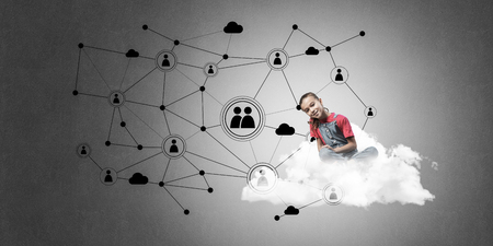 Cute smiling girl sitting on cloud presenting social connection conceptの写真素材