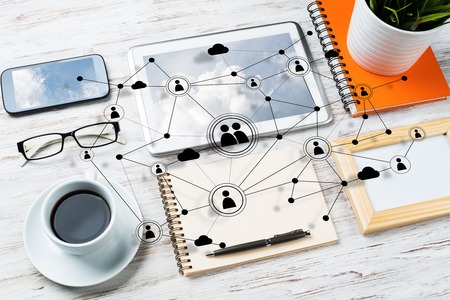 Top view of modern workplace with office stuff and social network connection above presenting still...