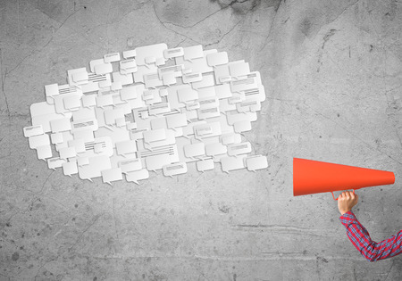 Close of woman making announcement in paper trumpetの写真素材