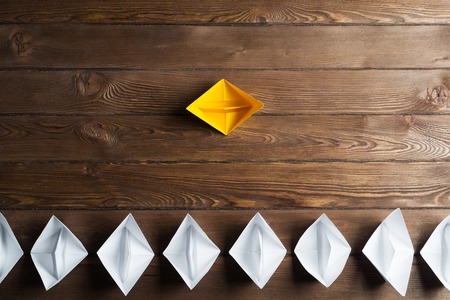 Set of origami boats on wooden tableの写真素材