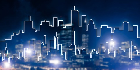 Modern night city scape glowing with lights and its drawn silhouetteの写真素材