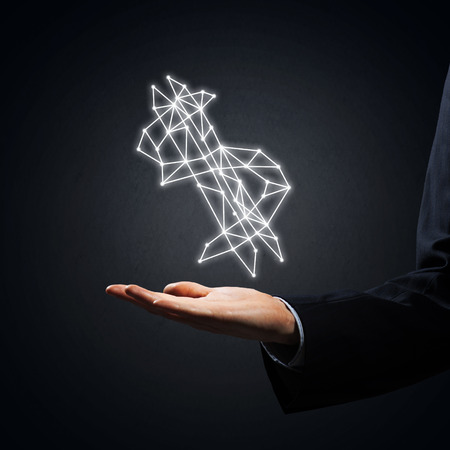 Close of businessman hand showing in palm glowing dollar signの写真素材