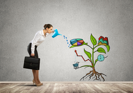 Attractive businesswoman presenting investment and financial growth conceptの写真素材