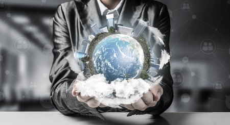 Closeup of businessman in suit keeping in hands Earth globe with buildings, office view on...