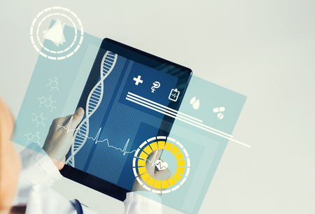 Tablet pc device with medicine interface screen in hands of doctorの写真素材