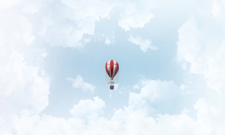 Colorful aerostat flying over the blue cloudy sky. 3D rendering.の写真素材