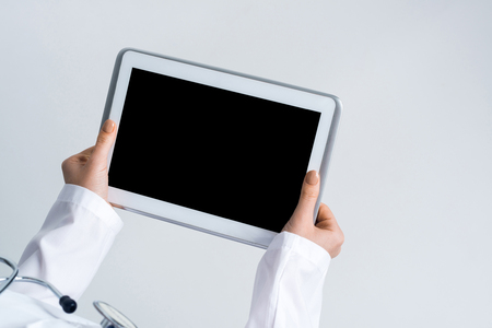 Tablet pc device with blank screen in hands of doctorの写真素材