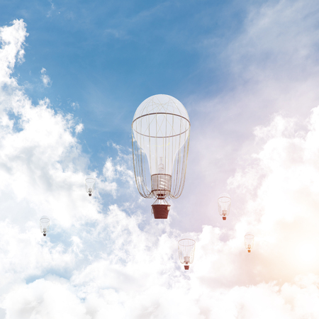 Colorful aerostats flying over the blue cloudy sky. 3D rendering.の写真素材