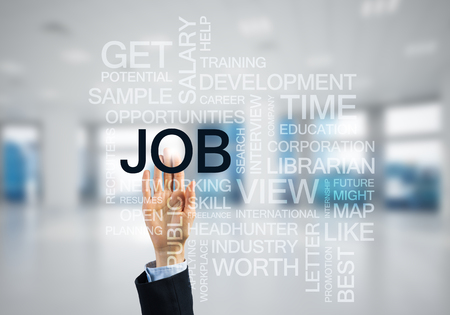 Close of businesswoman hand touching screen with business conceptual wordsの写真素材