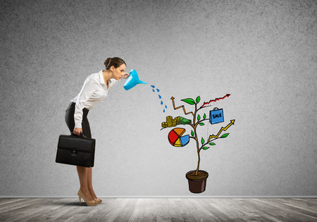 Attractive businesswoman presenting investment and financial growth conceptの写真素材