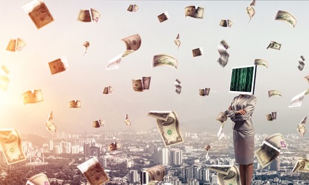 Cropped image of business woman in suit with monitor instead of head keeping arms crossed while standing outdoors among flying dollars with cityscape view on background.の写真素材