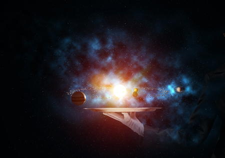Cropped image of waitresss hand in white glove presenting glowing solar system on metal tray with dark cosmic background. 3D rendering.の写真素材