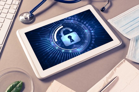 Doctors workplace with white tablet stethoscope and maskの写真素材