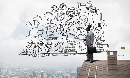 Faceless businessman with camera zoom instead of head standing on house roofの写真素材