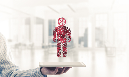 Close of businessman holdingn tablet pc with office worker figure. Mixed mediaの写真素材