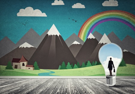 Businesswoman inside light bulb in room against nature drawn conceptの写真素材