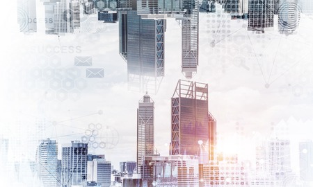 Abstract image of two modern urban worlds located upside down to each other on sky background and media interface. Double exposure. Wallpaper, backdrop with copyspace.の写真素材