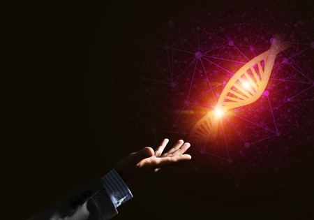 Close of businessman hand presenting DNA molecule research as concept. Mixed mediaの写真素材