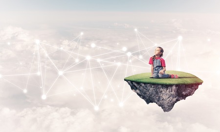 Cute smiling girl on floating island presenting social connection conceptの写真素材