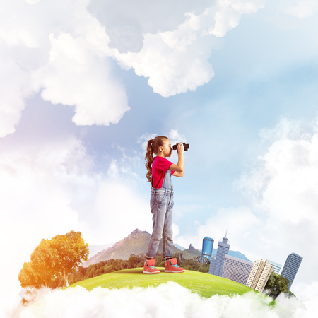 Cute kid girl on city floating island looking in binocularsの写真素材
