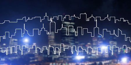 Modern night city scape glowing with lights and its drawn silhouetteの写真素材