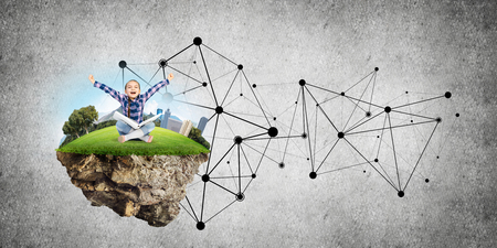 Connection concept floating island and happy kid girl with book sitting on itの写真素材