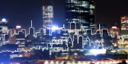 Modern night city scape glowing with lights and its drawn silhouetteの写真素材