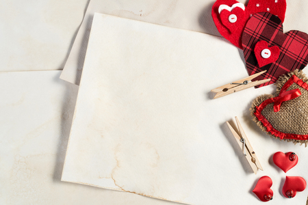 Handmade love hearts and sheets of blank paper の写真素材