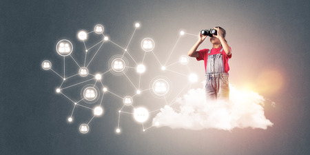 Cute smiling little girl on cloud representing social connection conceptの写真素材