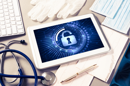 Doctors workplace with white tablet stethoscope and maskの写真素材