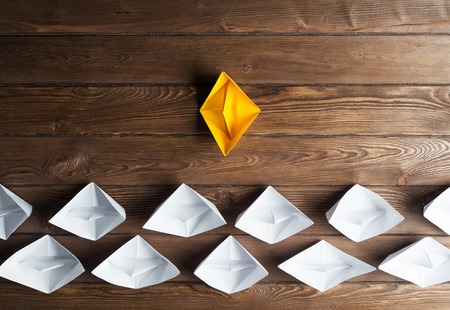 Set of origami boats on wooden tableの写真素材