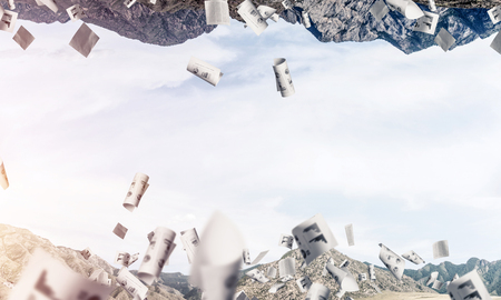 Abstract image of two nature worlds located among flying papers and upside down to each other on sky background. Wallpaper, backdrop with copyspace.の写真素材