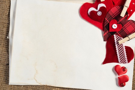 Handmade love hearts and sheets of blank paperの写真素材
