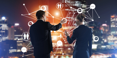 Businessman and businesswoman standing with back and touching connection conceptの写真素材
