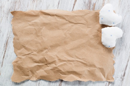 Brown package paper and love hearts on wooden backgroundの写真素材