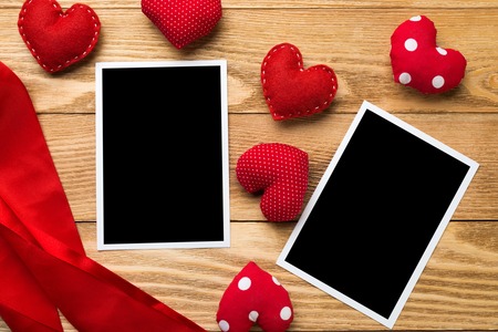 Blank instant photo and love hearts on wooden table backgroundの写真素材