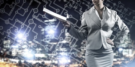 Businesswoman wearing modern suit and holding contract or report in her handの写真素材