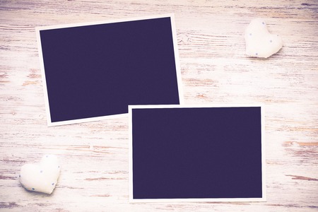 Blank photo frame and love hearts on wooden tableの写真素材