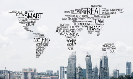 Business-related terms collage in form of world map with modern cityscape on background.の写真素材