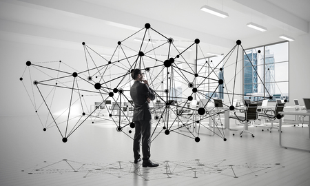 Elegant businessman in modern office interior and social connection concept. Mixed mediaの写真素材