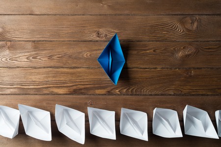 Set of origami boats on wooden tableの写真素材