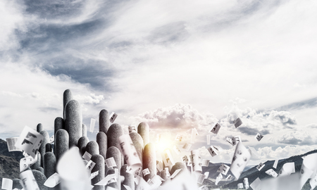 Image of high and huge stone columns located outdoors among flying papers with beautiful landscape on background. Wallpaper, backdrop with copyspace.の写真素材