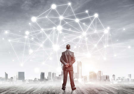 Businessman standing with back and looking at network drawn conceptの写真素材