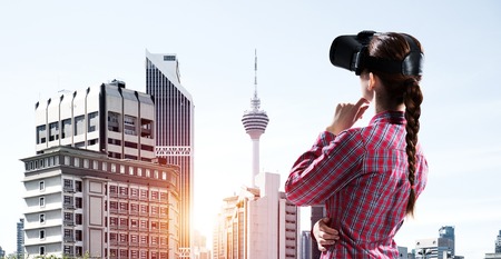 Young caucasian woman in virtual reality helmet against cityscape background