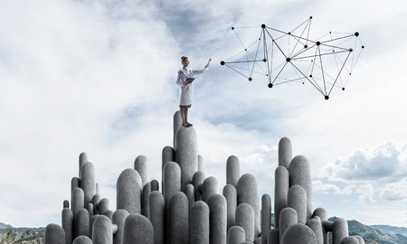Young female doctor with folder in hands satnding on stone column. 3d renderingの写真素材