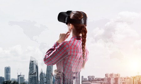 Young caucasian woman in virtual reality helmet against cityscape background