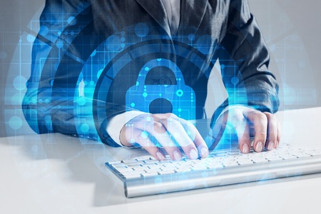 Close up of female hands using computer keyboard and lock icon on screen